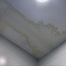 A large water leak on a white ceiling